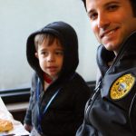 police officer and child eating breakfast